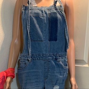 Faded torn denim overalls